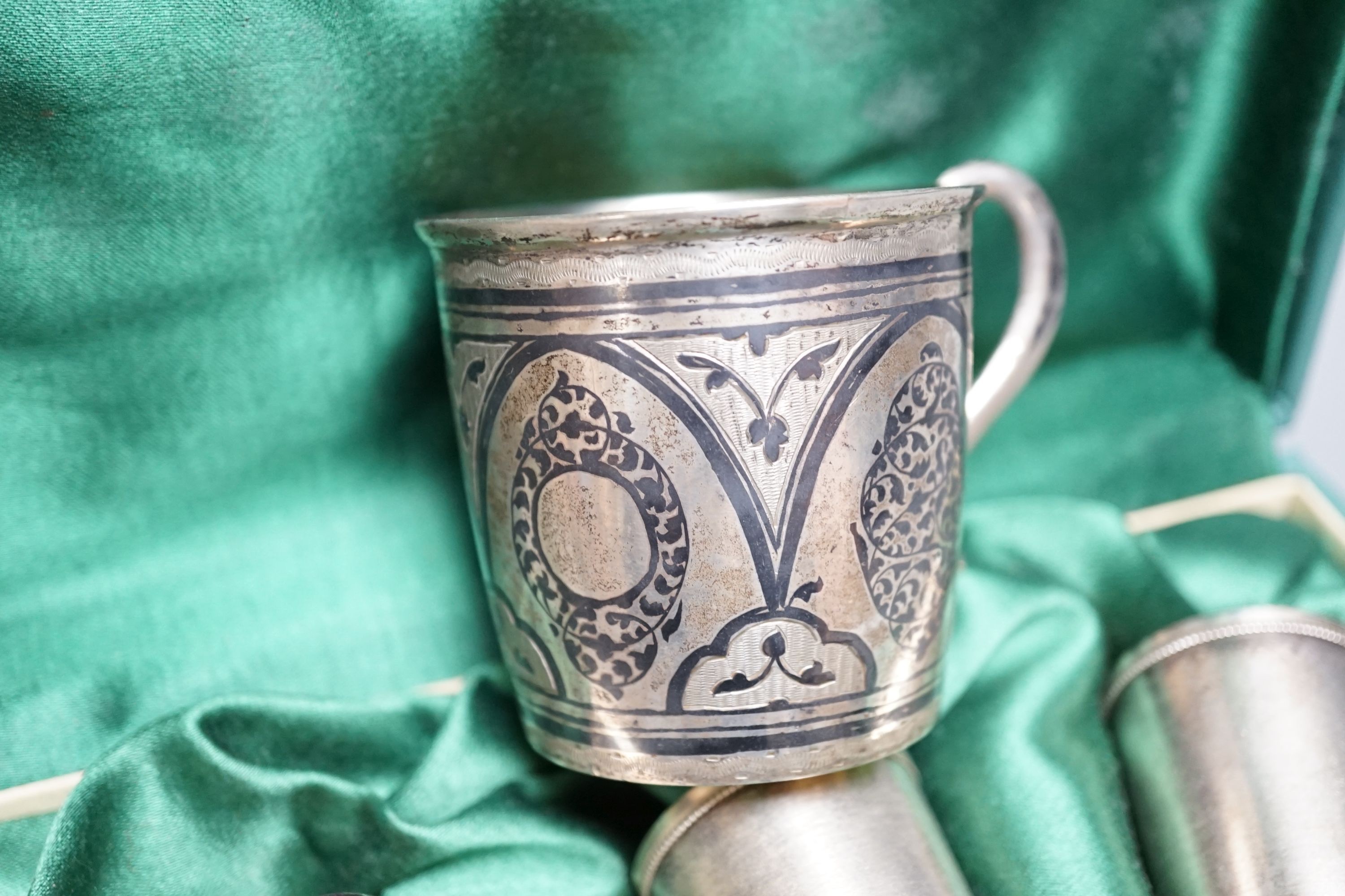 A cased set of six mid 20th century Soviet Union white metal tots, 5cm and an earlier 875 zolotnik and niello mug.